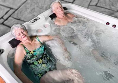 An eldery couple relaxing in the hot tub